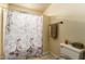 Cozy bathroom with an Eiffel Tower shower curtain and tan colored walls at 3137 W Baseline Rd, Laveen, AZ 85339