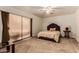 Cozy bedroom with soft carpet, a plush bed, and warm lighting that creates a welcoming space at 3137 W Baseline Rd, Laveen, AZ 85339