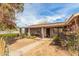 Quaint front yard with a rustic fence and mature plants leading to the entrance at 3137 W Baseline Rd, Laveen, AZ 85339