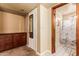 Hallway view to basement bathroom with Eiffel Tower shower curtain and vanity with storage at 3137 W Baseline Rd, Laveen, AZ 85339