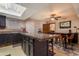 Open concept kitchen with island and adjacent breakfast area that has natural light and plenty of seating at 3137 W Baseline Rd, Laveen, AZ 85339