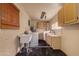 Functional laundry room with a sink, modern washer and dryer, and ample cabinet space at 3137 W Baseline Rd, Laveen, AZ 85339