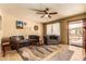 Cozy living room with ceiling fan, neutral decor, and hardwood floors at 3137 W Baseline Rd, Laveen, AZ 85339