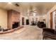 Expansive living room with a brick fireplace, neutral carpet, and open access to dining area at 3137 W Baseline Rd, Laveen, AZ 85339