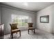 Living room featuring neutral walls, large window and comfortable sitting area with chairs at 3137 W Baseline Rd, Laveen, AZ 85339