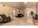 A comfortable living area featuring plush seating, a fireplace, and easy access to other living spaces at 3137 W Baseline Rd, Laveen, AZ 85339