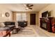 Cozy living room featuring plush seating, decorative fireplace, and ceiling fan for comfortable living at 3137 W Baseline Rd, Laveen, AZ 85339