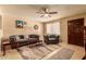 Bright living room featuring neutral decor, wood-look floors, and ceiling fan at 3137 W Baseline Rd, Laveen, AZ 85339