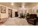 Comfortable living space transitioning into the dining area, showcasing an open floor plan and neutral finishes at 3137 W Baseline Rd, Laveen, AZ 85339