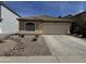 Attractive single-story home featuring desert landscaping, tile roof, and attached two-car garage at 37959 N Luke Ln, San Tan Valley, AZ 85140
