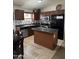 Kitchen with stainless steel appliances, dark wood cabinetry, and a central island at 37959 N Luke Ln, San Tan Valley, AZ 85140