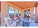 Covered patio featuring comfortable seating and a fire pit for relaxation at 40314 W Marion May Ln, Maricopa, AZ 85138