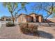 Well-maintained single-story home with a desert landscape, a front porch, and a two-car garage at 40314 W Marion May Ln, Maricopa, AZ 85138