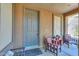 Cozy front porch with comfortable seating, a welcome mat, and a stylish front door at 40314 W Marion May Ln, Maricopa, AZ 85138