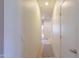 Bright hallway featuring neutral walls and carpeting leading to other rooms at 40314 W Marion May Ln, Maricopa, AZ 85138
