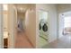 Hallway view with laundry room and bedroom visible, showcasing layout at 40314 W Marion May Ln, Maricopa, AZ 85138