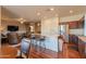 Open-concept kitchen with an island, bar stools, and stainless steel appliances at 40314 W Marion May Ln, Maricopa, AZ 85138