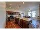 Stylish kitchen with dark cabinetry, an island, stainless appliances, and wood flooring at 40314 W Marion May Ln, Maricopa, AZ 85138