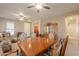 Bright open-concept space featuring a dining area and living room perfect for entertaining guests at 40314 W Marion May Ln, Maricopa, AZ 85138