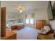 Large main bedroom with a ceiling fan, sitting area, and natural lighting at 40314 W Marion May Ln, Maricopa, AZ 85138