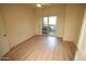 Bedroom features wood floors, a ceiling fan, and balcony access at 435 W Rio Salado Pkwy # 210, Tempe, AZ 85281