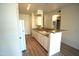 Functional kitchen with wood-look floors, white cabinets, and a breakfast bar at 435 W Rio Salado Pkwy # 210, Tempe, AZ 85281