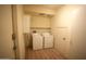 Functional laundry room with washer, dryer, shelving, and storage cabinet at 435 W Rio Salado Pkwy # 210, Tempe, AZ 85281
