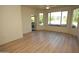 Bright living room featuring wood floors, ceiling fan, large windows, and balcony access at 435 W Rio Salado Pkwy # 210, Tempe, AZ 85281