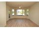 Bright living room featuring wood floors, ceiling fan, large windows, and balcony access at 435 W Rio Salado Pkwy # 210, Tempe, AZ 85281