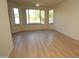 Bright living room featuring wood floors, ceiling fan, large windows, and balcony access at 435 W Rio Salado Pkwy # 210, Tempe, AZ 85281