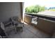 A cozy patio area with decorative outdoor furniture and a view of a green tree at 435 W Rio Salado Pkwy # 210, Tempe, AZ 85281
