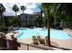 Inviting pool with lounge chairs, palm trees, and a view of the building complex at 435 W Rio Salado Pkwy # 210, Tempe, AZ 85281