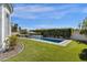 Expansive backyard featuring a pristine pool, manicured lawn, and ample space for outdoor enjoyment at 4457 E Fountain St, Mesa, AZ 85205