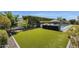 Lush backyard featuring artificial turf, comfortable lounge seating, and well-manicured landscaping at 4457 E Fountain St, Mesa, AZ 85205