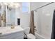 Bright bathroom featuring a shower over the tub, toilet, single sink vanity, and window providing natural light at 4457 E Fountain St, Mesa, AZ 85205