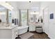 Luxurious bathroom featuring double sinks, a standalone tub, and stylish finishes, perfect for relaxation at 4457 E Fountain St, Mesa, AZ 85205