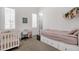 Charming bedroom features a crib, a daybed with storage, and shuttered windows for soft lighting at 4457 E Fountain St, Mesa, AZ 85205