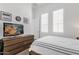 Bright bedroom with natural light, a wooden dresser, and a modern TV for a cozy retreat at 4457 E Fountain St, Mesa, AZ 85205