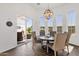 Bright dining room features a globe chandelier, wood floors, and access to an outdoor patio at 4457 E Fountain St, Mesa, AZ 85205