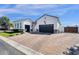 Gorgeous home with a brick driveway leading to a spacious two-car garage at 4457 E Fountain St, Mesa, AZ 85205