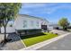 Charming white home with well-manicured lawn and attractive landscaping at 4457 E Fountain St, Mesa, AZ 85205