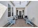 Inviting front entrance with seating, potted plants, and decorative door at 4457 E Fountain St, Mesa, AZ 85205