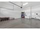 Clean and organized garage with epoxy floor, storage shelves and room for parking and projects at 4457 E Fountain St, Mesa, AZ 85205