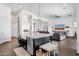 Open-concept living with kitchen featuring an island, pendant lights, and white cabinets at 4457 E Fountain St, Mesa, AZ 85205