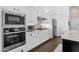 Updated kitchen boasts white cabinetry, stainless steel appliances, and modern finishes at 4457 E Fountain St, Mesa, AZ 85205