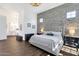 Serene main bedroom featuring a brick accent wall and ample natural light at 4457 E Fountain St, Mesa, AZ 85205