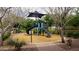 Inviting playground with slide, climbing structure, and shade, surrounded by trees and landscaping at 4457 E Fountain St, Mesa, AZ 85205