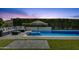 Backyard pool with stone patio, outdoor seating and lush landscaping, creating an ideal space for relaxation at 4457 E Fountain St, Mesa, AZ 85205