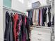 Organized walk-in closet with clothing racks and built-in storage shelves for optimal storage and functionality at 4457 E Fountain St, Mesa, AZ 85205