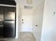 Bright entryway featuring a stainless steel refrigerator and dark cabinets in a condominium setting at 4750 N Central Ave # 1N, Phoenix, AZ 85012